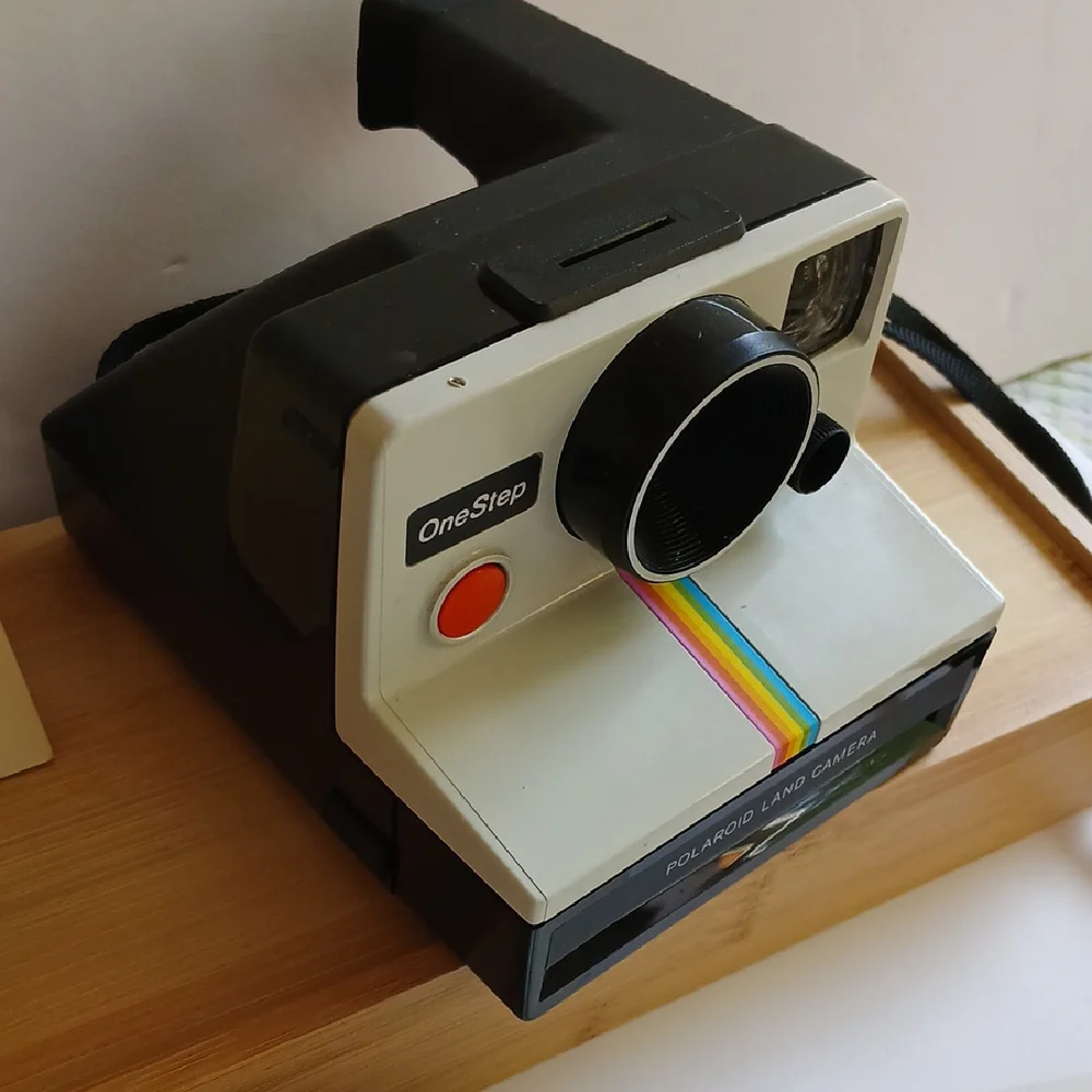 Vintage Polaroid Land One Step Instant Film Camera with Iconic Rainbow Design